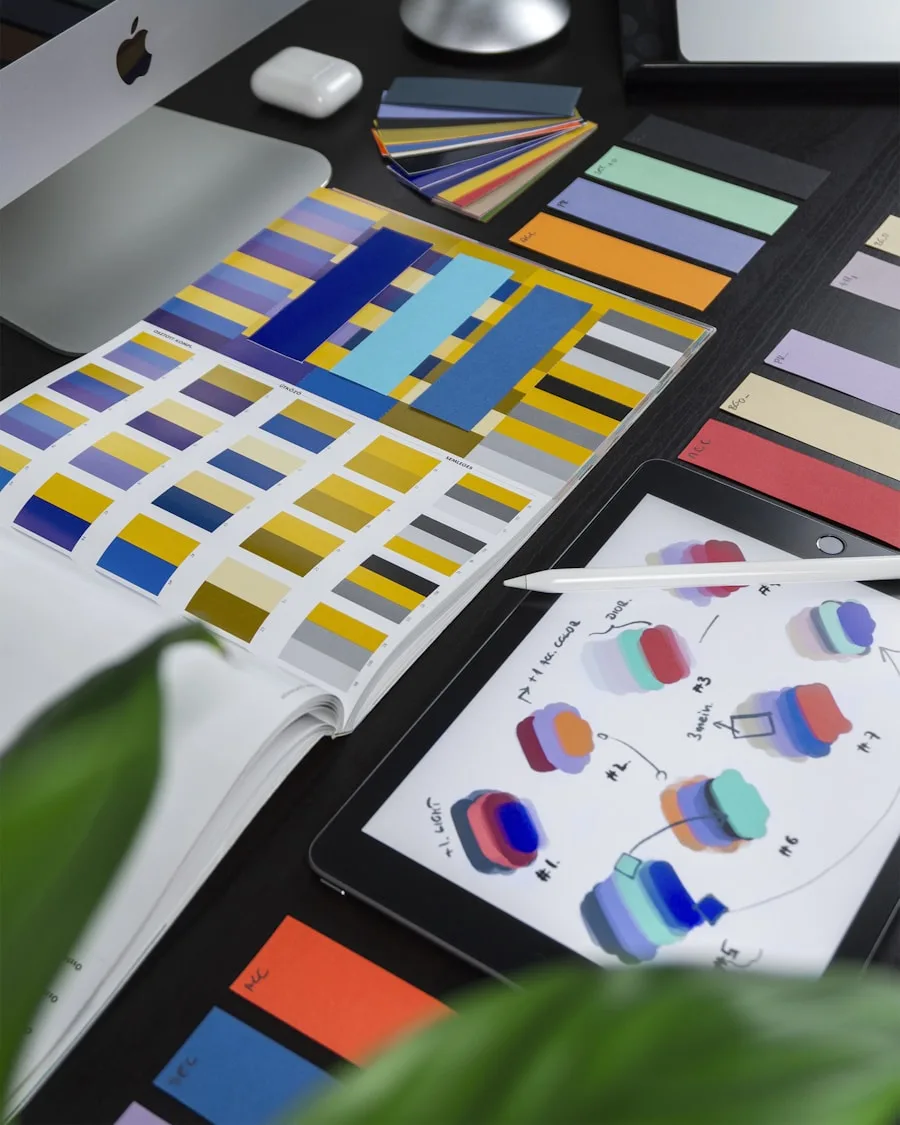 A designer's workspace shows color swatches, a tablet and laptop for creative arts projects.